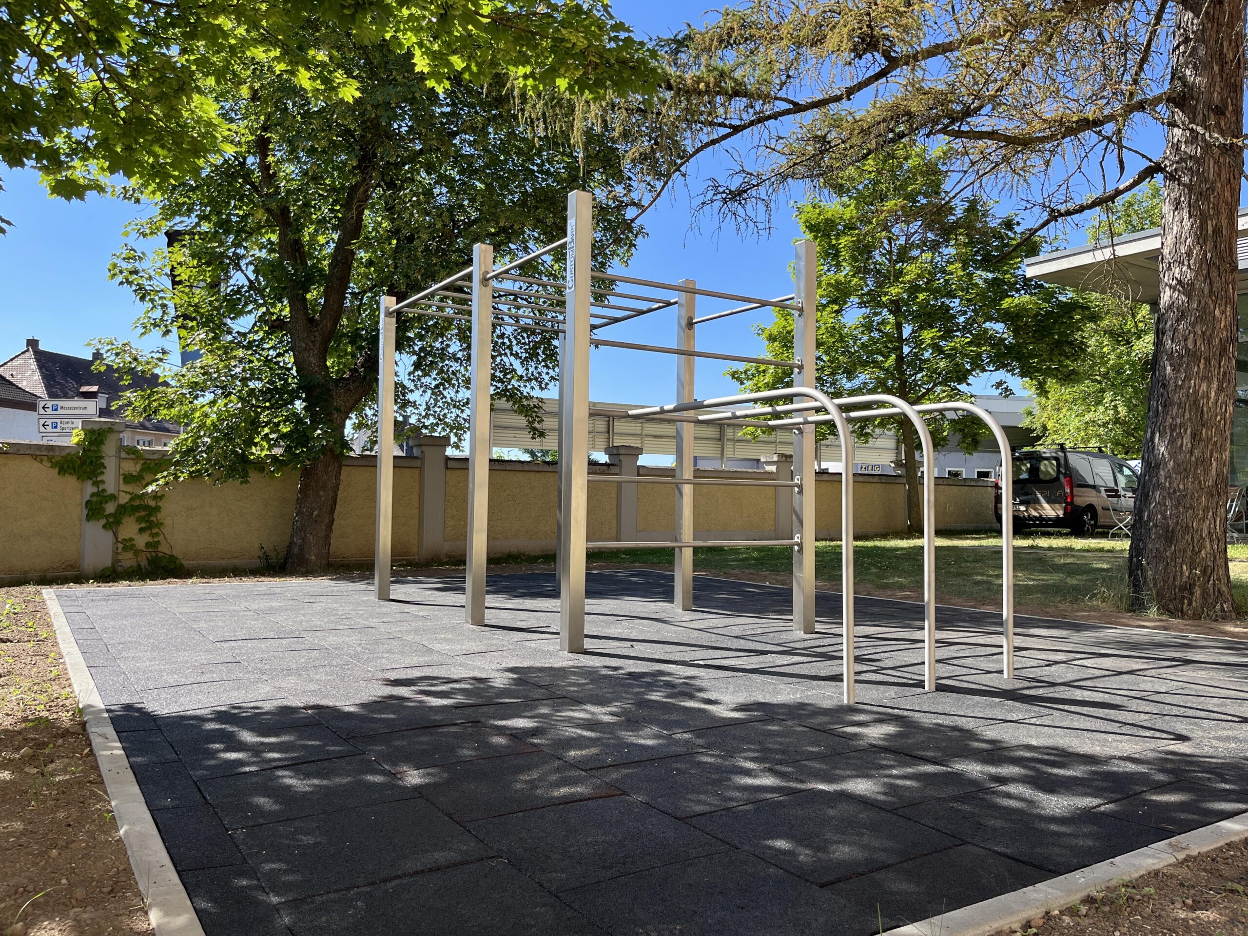 ein Gelände mit einem Calisthenics Park mit Barren und Gerüsten in unterschiedlichen Höhen